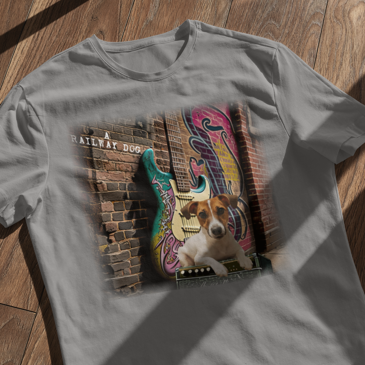 This t-shirt combines a Jack Russell Terrier dog with a classic Fender Stratocaster electric guitar in a graphic image.